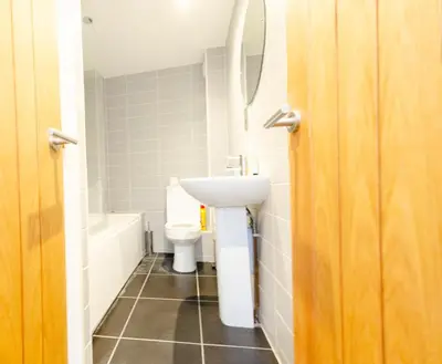 a bathroom with a sink and a toilet at Cozy 2BR 2BATH Apt in Central Ipswich - Sleeps 6 & Prime Location in Ipswich