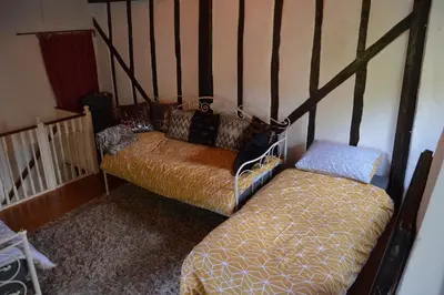 a living room with a couch and a bed at Countryside Tiny House in Roydon