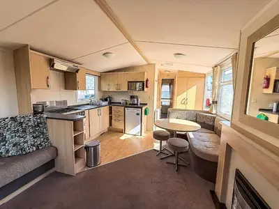 a kitchen and living room of a caravan at Cosy Caravan With Decking At Oaklands Holiday Park In Essex Ref 39042Cf in Clacton-on-Sea