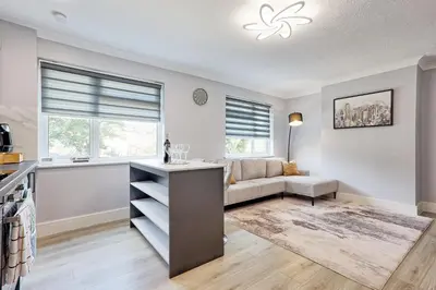 a living room with a couch and a table at 5 Bedroom Apartment - Weekly Deal - By Homestyles Hosts Short Lets and Serviced Accommodation Widford - Free Parking in Writtle