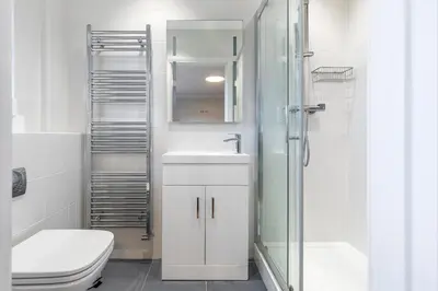 a bathroom with a toilet and a sink and a shower at Relaxing Coastal Getaway Perfect for Families in Canvey Island