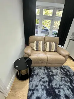 a living room with a couch and a rug at A Comfortable and Cosy Self Contained Room in Navestock