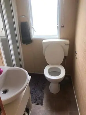 a bathroom with a white toilet and a sink at Seaside caravan in Clacton-on-Sea