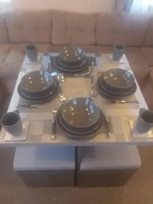 a table with plates and utensils on it at Seaside caravan in Clacton-on-Sea