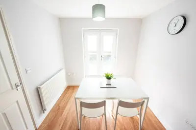 a dining room with a table and two chairs at 3bed town house- Superking Beds-fast WI-FI-Parking in Colchester