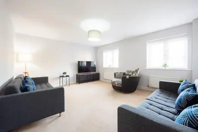 a living room with two couches and a tv at 3bed town house- Superking Beds-fast WI-FI-Parking in Colchester