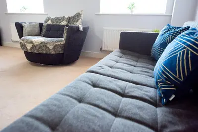 a living room with a couch and a chair at 3bed town house- Superking Beds-fast WI-FI-Parking in Colchester