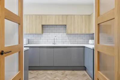 a kitchen with white cabinets and a sink at 2 Royal Serviced Apartments, Ground Floor, two Bed,Fast Wifi - Space in Parkeston