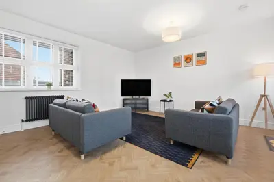 a living room with two couches and a flat screen tv at 2 Royal Serviced Apartments, Ground Floor, two Bed,Fast Wifi - Space in Parkeston