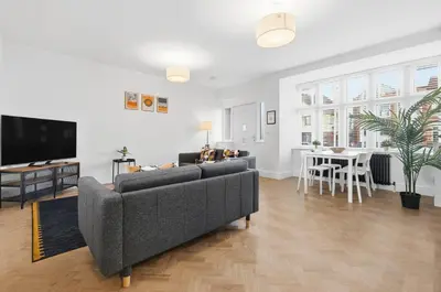 a living room with a couch and a tv and a table at 2 Royal Serviced Apartments, Ground Floor, two Bed,Fast Wifi - Space in Parkeston