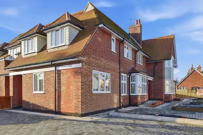 a red brick house with white windows on a street at 2 Royal Serviced Apartments, Ground Floor, two Bed,Fast Wifi - Space in Parkeston