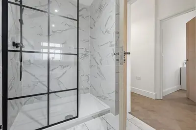 a bathroom with a shower with a glass door at 2 Royal Serviced Apartments, Ground Floor, two Bed,Fast Wifi - Space in Parkeston
