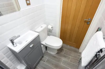 a white bathroom with a toilet and a sink at 3 Bed 2.5 Bath Detached House,Parking,Pet Friendly in Parkeston