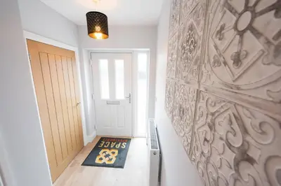 a hallway with a door and a rug on the floor at 3 Bed 2.5 Bath Detached House,Parking,Pet Friendly in Parkeston