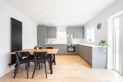 a kitchen with a wooden table and black chairs at 3 Bed 2.5 Bath Detached House,Parking,Pet Friendly in Parkeston