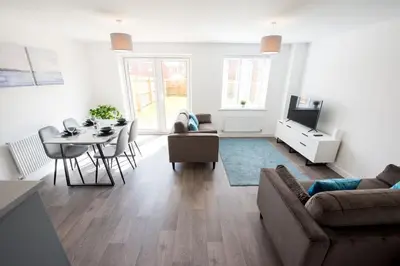 a living room with a couch and a dining room at House -Superking Beds-Garden-FastWifi-Pet Friendly in Broomfield
