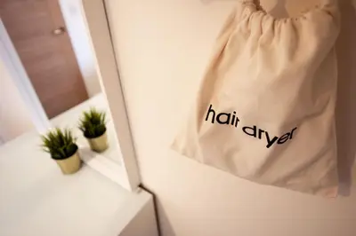 a bag hanging on a wall next to a mirror at 7 The Royal Serviced Apartments Harwich, Fair WiFi, Private Parking in Parkeston