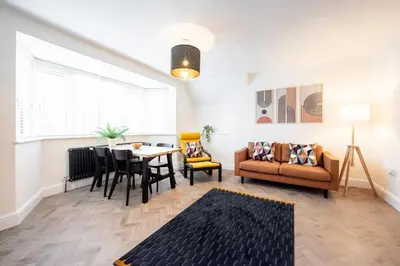 a living room with a couch and a table at 6 The Royal Serviced Apartments, Harwich - Fast WiFi, Private Parking in Parkeston