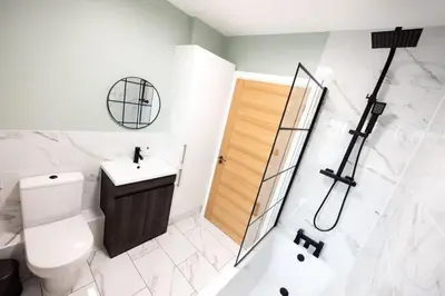a bathroom with a toilet and a shower and a sink at 6 The Royal Serviced Apartments, Harwich - Fast WiFi, Private Parking in Parkeston