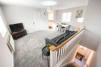 a living room with a couch and a table at Two Double Bed Coach House with Parking Fast WiFi in Colchester