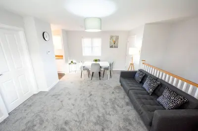a living room with a couch and a table at Two Double Bed Coach House with Parking Fast WiFi in Colchester