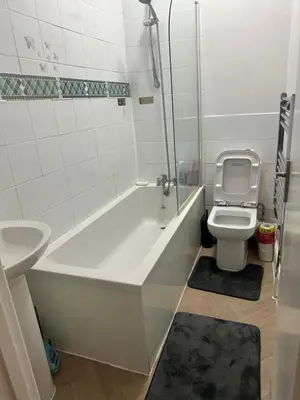 a bathroom with a toilet and a tub and a sink at The Retreat On Retreat Road in Southend-on-Sea