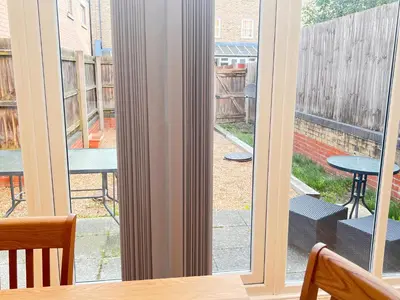 a window with a view of a patio at 4 Bedroom House Colchester in Colchester