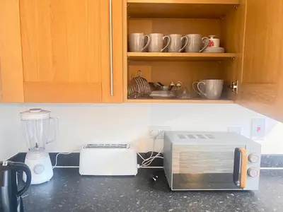 a kitchen counter with a toaster and a blender at 4 Bedroom House Colchester in Colchester