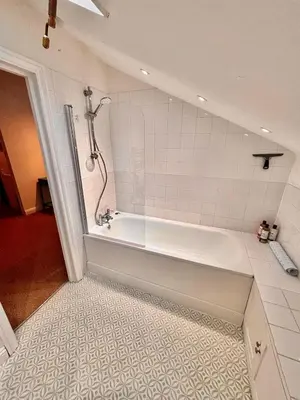 a bathroom with a bath tub with a shower at One Threadneedle Street, Dedham in Dedham