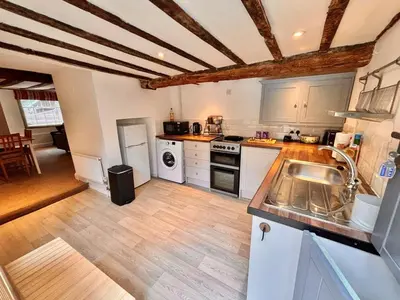 a kitchen with white appliances and a wooden floor at One Threadneedle Street, Dedham in Dedham