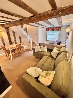 a living room with a couch and a table at One Threadneedle Street, Dedham in Dedham