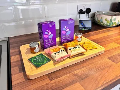 a cutting board with two boxes of food on a counter at One Threadneedle Street, Dedham in Dedham