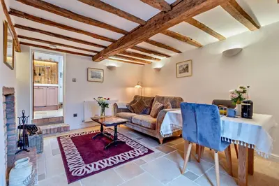 a living room with a couch and a table at 1 Bed in Snape oc-a30669 in Snape