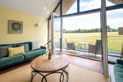 a living room with a couch and a table at Sedge House, Eastbridge, Close to the coast, RSPB Nature Reserve, Dunwich, Sizewell and Leiston - Managed by Aldeburgh Coastal Cottages in Theberton
