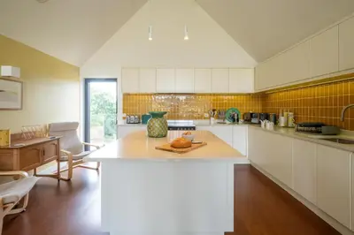a kitchen with a large island in the middle at Sedge House, Eastbridge, Close to the coast, RSPB Nature Reserve, Dunwich, Sizewell and Leiston - Managed by Aldeburgh Coastal Cottages in Theberton