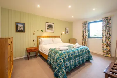 a bedroom with a bed and a window at Sedge House, Eastbridge, Close to the coast, RSPB Nature Reserve, Dunwich, Sizewell and Leiston - Managed by Aldeburgh Coastal Cottages in Theberton