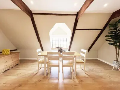 a dining room with a table and chairs and a window at Carleys Yard by The Suffolk Cottage Collection in Framlingham