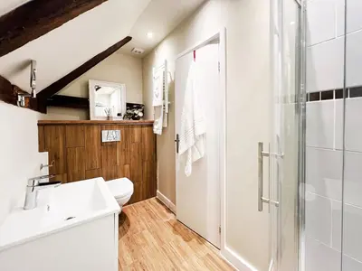 a bathroom with a sink and a shower at Carleys Yard by The Suffolk Cottage Collection in Framlingham