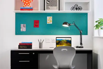 a desk with a white chair and a lamp at For Students Only - The Maltings in Colchester in Colchester