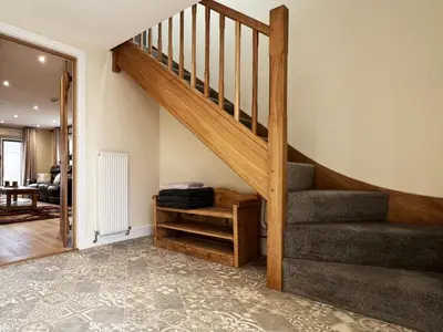 a staircase in a home with a living room at Blackberry Barn by The Suffolk Cottage Collection in Long Melford