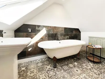 a bathroom with a sink and a bath tub at Blackberry Barn by The Suffolk Cottage Collection in Long Melford
