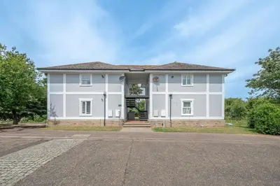 a large white house with a driveway at 19BC, Aldeburgh in Aldeburgh