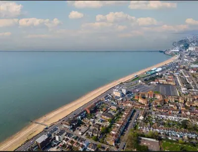 an aerial view of a beach next to the water at Stylish 3 Bed Seaside Apartment Central Southend Location & Steps from the Beach in Southend-on-Sea