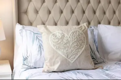 a pillow with a heart on top of a bed at Stylish 3 Bed Seaside Apartment Central Southend Location & Steps from the Beach in Southend-on-Sea