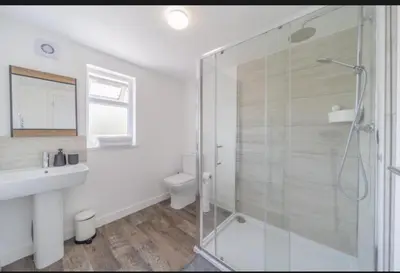 a bathroom with a shower and a sink and a toilet at Stylish 3 Bed Seaside Apartment Central Southend Location & Steps from the Beach in Southend-on-Sea