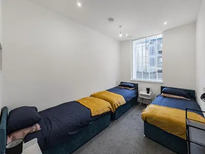 a bedroom with two beds and a window at Stylish 1B Apt in Essex w Modern Touch in Chelmsford