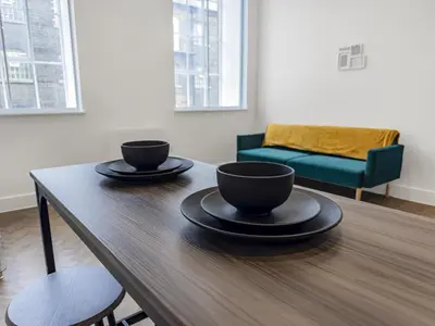 two cups on a wooden table in a living room at Stylish 1B Apt in Essex w Modern Touch in Chelmsford