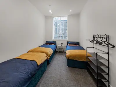 two beds in a room with a window at Stylish 1B Apt in Essex w Modern Touch in Chelmsford