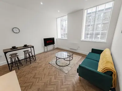 a living room with a couch and a table at Stylish 1B Apt in Essex w Modern Touch in Chelmsford