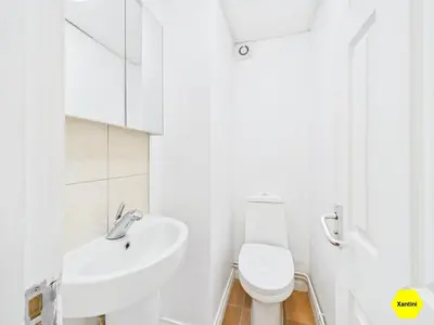 a white bathroom with a sink and a toilet at New Spacious apartment in Milton
